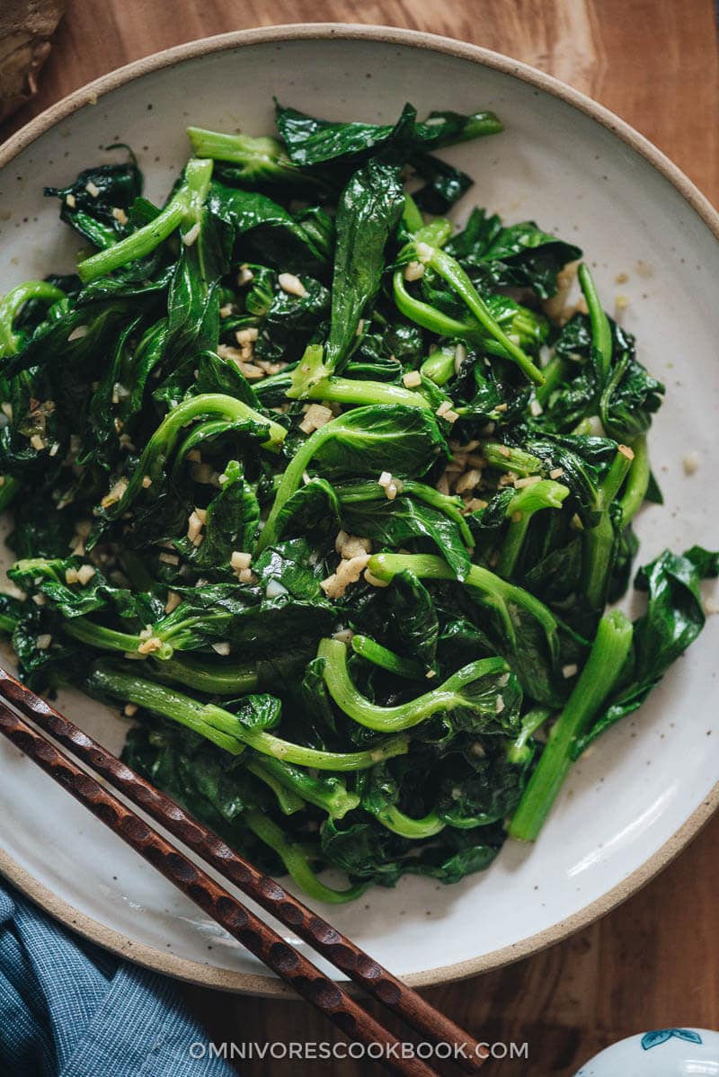 Stir-Fried Pea Shoots with Garlic - Tender crisp stir-fried pea shoots with plenty of aromatics to create a mouth-watering dish that you can’t stop eating. The post includes all the notes and tips to walk you through the process step-by-step to create a restaurant-style result. {Vegan, Gluten-Free adaptable} Homemade stir-fried pea shoots with garlic close up